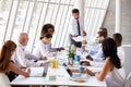 Hispanic Businessman Leading Meeting At Boardroom Table Royalty Free Stock Photo