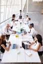 Hispanic Businessman Leading Meeting At Boardroom Table Royalty Free Stock Photo