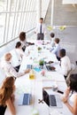 Hispanic Businessman Leading Meeting At Boardroom Table Royalty Free Stock Photo