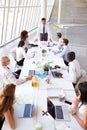 Hispanic Businessman Leading Meeting At Boardroom Table Royalty Free Stock Photo