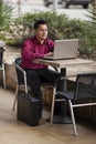 Hispanic Businessman - Telecommuting Internet Cafe