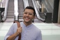 Hispanic businessman using moving staircase Royalty Free Stock Photo