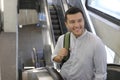 Hispanic businessman using moving staircase Royalty Free Stock Photo