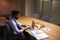 Hispanic businessman working late in office, elevated view