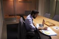 Hispanic businessman working late in office, elevated view