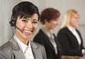 Hispanic Businesswoman with Colleagues Behind