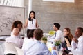 Hispanic Businesswoman Leading Meeting At Boardroom Table Royalty Free Stock Photo