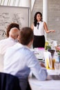 Hispanic Businesswoman Leading Meeting At Boardroom Table Royalty Free Stock Photo