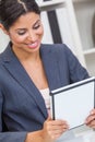 Hispanic Businesswoman Using Tablet Computer In An Office Royalty Free Stock Photo