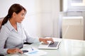 Hispanic businesswoman working with her laptop