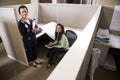 Hispanic businesswomen in cubicle Royalty Free Stock Photo