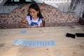 hispanic child girl playing making magic tricks with cards