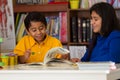 Hispanic Child Learning to Read with Mom