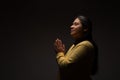 Hispanic Christian Woman Praying or Talking to God on Dark Background