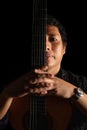 hispanic classical guitarist guitar player on a black background, studio shot portrait Royalty Free Stock Photo