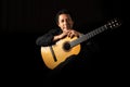 hispanic classical guitarist guitar player on a black background, studio shot portrait