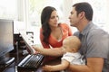 Hispanic couple and baby in home office Royalty Free Stock Photo