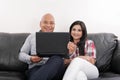 Hispanic Couple on Black Couch