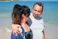 Hispanic couple calm and relax hugging each other standing at the beach during summer Royalty Free Stock Photo