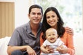 Hispanic couple at home with baby Royalty Free Stock Photo