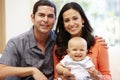 Hispanic couple at home with baby Royalty Free Stock Photo