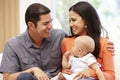 Hispanic couple at home with baby Royalty Free Stock Photo