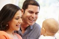 Hispanic couple at home with baby Royalty Free Stock Photo