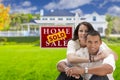 Hispanic Couple, New Home and Sold Real Estate Sign Royalty Free Stock Photo