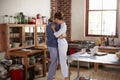 Hispanic couple in pyjamas embracing in kitchen Royalty Free Stock Photo