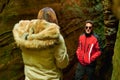 Hispanic couple standing between cliffs in Mullerhal national park in Luxembourg