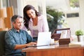 Hispanic Couple Using Laptop On Desk At Home Royalty Free Stock Photo