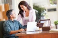 Hispanic Couple Using Laptop On Desk At Home Royalty Free Stock Photo