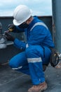 Hispanic Deck Officer on the deck of a seagoing vessel, wearing PPE