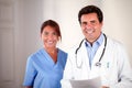 Hispanic doctor couple looking and smiling at you Royalty Free Stock Photo