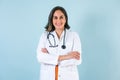 Hispanic doctor woman portrait with copy space over blue background laughing in Mexico Latin America Royalty Free Stock Photo