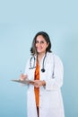 Hispanic doctor woman portrait with copy space over blue background laughing in Mexico Latin America Royalty Free Stock Photo