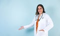 Hispanic doctor woman portrait with copy space over blue background laughing in Mexico Latin America Royalty Free Stock Photo