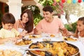 Hispanic Family Enjoying Outdoor Meal At Home Together Royalty Free Stock Photo