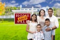 Hispanic Family in Front of Sold Real Estate Sign, House Royalty Free Stock Photo