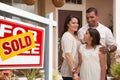 Hispanic Family in Front of Their New Home Royalty Free Stock Photo