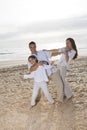 Hispanic family with girl having fun on beach Royalty Free Stock Photo