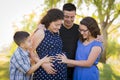 Hispanic Family Hands on Pregnant Mother Tummy Feeling Baby Kick Royalty Free Stock Photo
