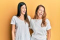 Hispanic family of mother and daughter wearing casual white tshirt winking looking at the camera with sexy expression, cheerful Royalty Free Stock Photo