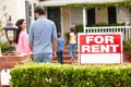 Hispanic family standing outside home for rent Royalty Free Stock Photo