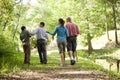 Hispanic family walking along trail in park Royalty Free Stock Photo