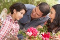 Hispanic Family Working In Garden Tidying Pots Royalty Free Stock Photo