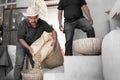 An Hispanic farmer is dropping coffee beans before peeling