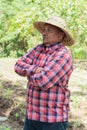 Hispanic farmer standing alone in his crop