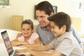 Hispanic Father And Children Using Computer At Home Royalty Free Stock Photo