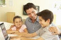 Hispanic Father And Children Using Computer At Home Royalty Free Stock Photo